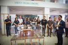 Students, faculty, and alumni gather around model of Larkin office building in new Hayes atrium. 