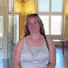 Katarina Voss standing in an architecturally significant building. 