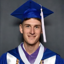 Peter Fillion wearing a graduation gown and cap. 