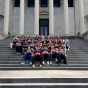 Students sitting outside on the southern stairs of the south campus library. 