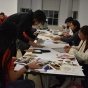 doubleASAP students working over a table. 