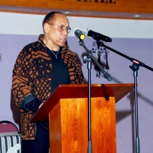 Henry Taylor speaks at podium. 