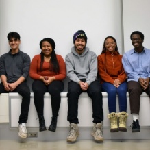 Members of AASAP sit together side by side in Hayes Hall. 