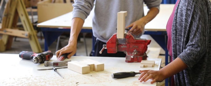 cordless drill, hammer and screwdriver on workbench with a vice. 