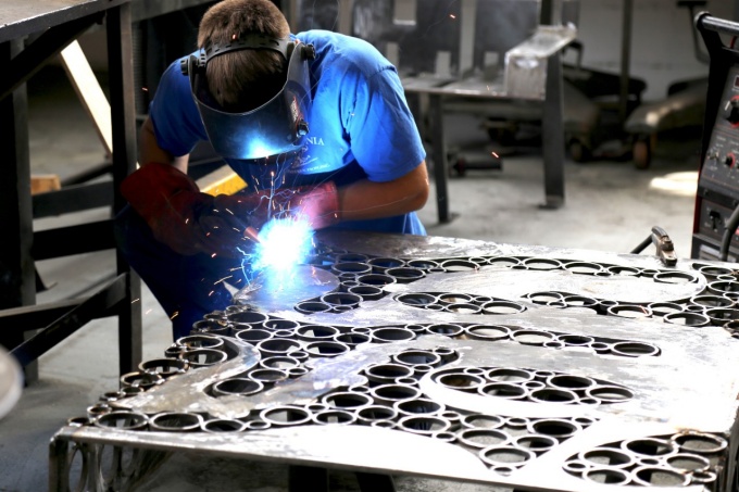 Student welding sheet of metal. 