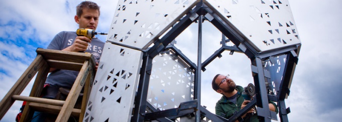Students build Elevator B, a 22-foot tower and home for bees in Silo City, a cluster of grain elevators along Buffalo's waterfront. 