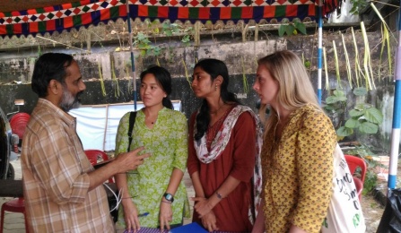 A student and on site construction manager talk together during an on site visit.
