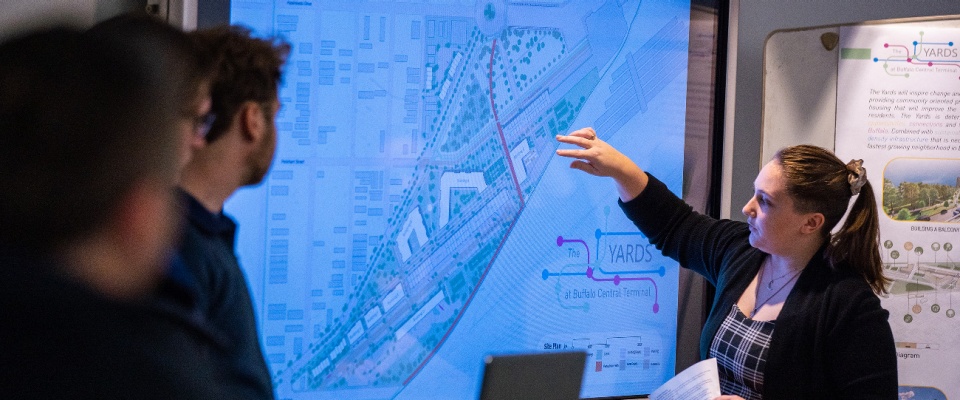 Master of Urban Planning student present their neighborhood plans to a group of community organizers. 
