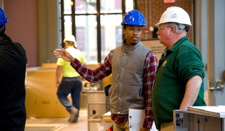 A student and on site construction manager talk together during an on site visit. 