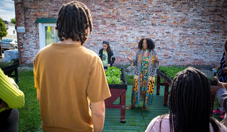 Gail V. Wells speaks to volunteers from the community, including UB Food Lab team members, who had gathered to distribute raised bed gardens to Buffalo residents through Buffalo Freedom Gardens. Photo: Douglas Levere. 