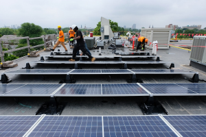 workers installing a rooftop solar array in Buffalo. 