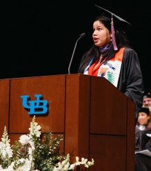 Nayarit Tineo speaking at the podium during the ceremony. 
