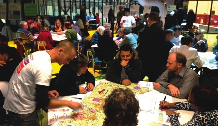 Photograph of community conversing at a public meeting. 