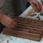 Zoom image: Participants in the 2016 Architectural Cereamic Assemblies Workshop mold, press and sculpt clay into bioclimatic facade components. The clay- storming sessions were held in Hayes Hall’s new attic studios. 