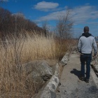 Photograph of Sean Burkholder walking along the waterfront. 