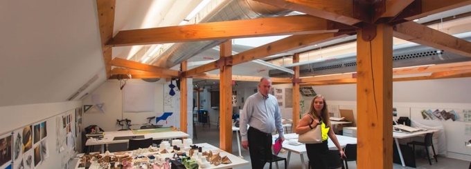 Photograph of guests exploring an architecture studio. 