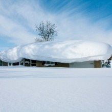 A photo of a house covered in seven feet of snow after an extreme snow event in Buffalo in 2014. 