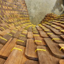 curving wood scaled skin sewn together.