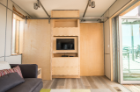 This student-designed storage unit dividing the bedroom and living area features a rotating television and entertainment platform to serve both rooms. Photo: Carl Burdick
