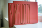 Each of the 120 terra cotta blocks that make up the new faculty mailboxes in Hayes Hall is etched with one of the 42 words that appeared, in sets of three, on the panels of the uppermost floor of the Frank Lloyd Wright-designed Larkin Administration Building in Buffalo, which was demolished in 1950. This one reads, "Simplicity." Photographer: Meredith Forrest Kulwicki