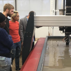 Students watch the water jet cut terra cotta during a demonstration and opening reception for the SMART Fabrication Factory in Parker Hall. 