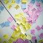 Pastel colors of sticky notes on a white table seen from above. 