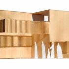 Wooden model with paper cutouts of people engaging with the space. 